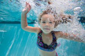 keep kids safe, girl underwater waving