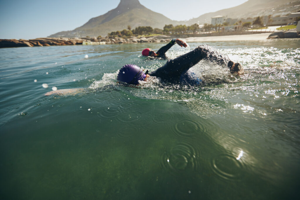 2 swimmers in wetsuits - preparing for your first triathlon 